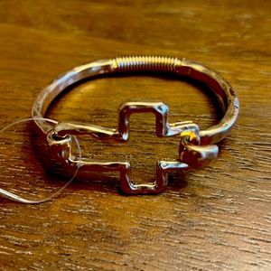 A new Pomina gold color cross bracelet.